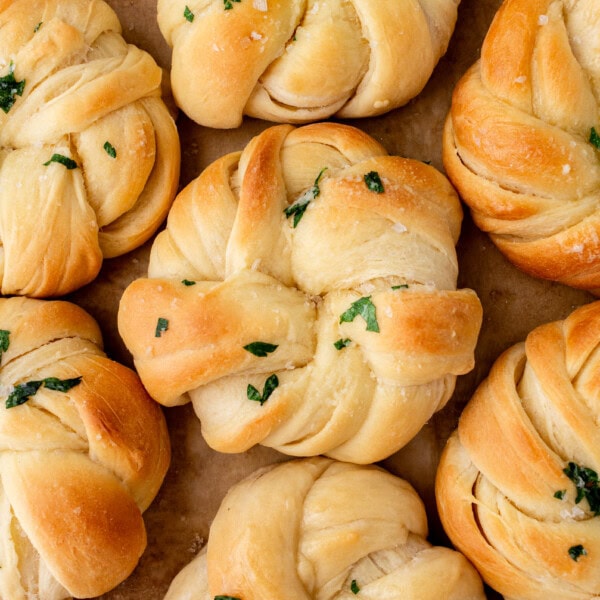 Buttery, fluffy homemade rolls tied in knot and brushed with butter. The perfect knotted rolls recipe!