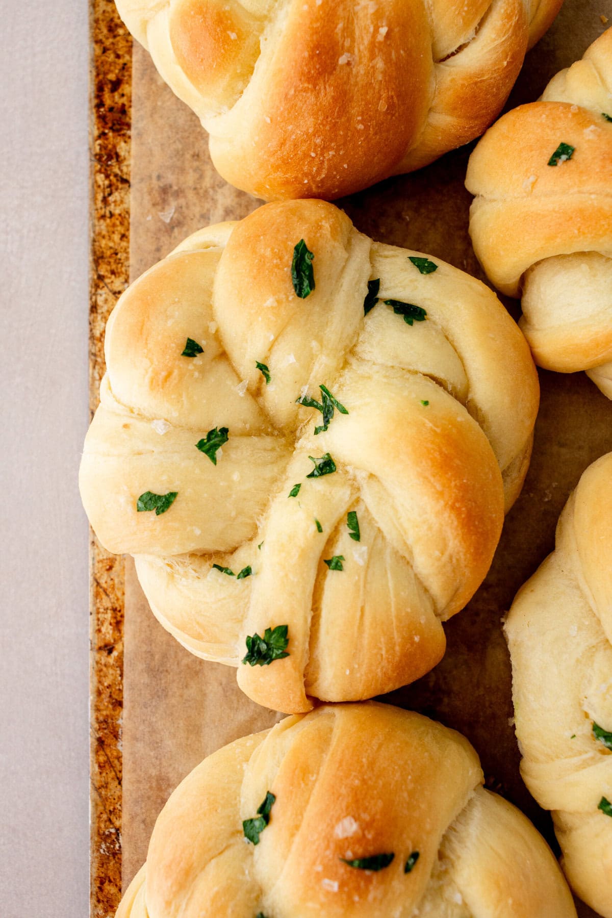 Buttery, fluffy homemade rolls tied in knot and brushed with butter. The perfect knotted rolls recipe!