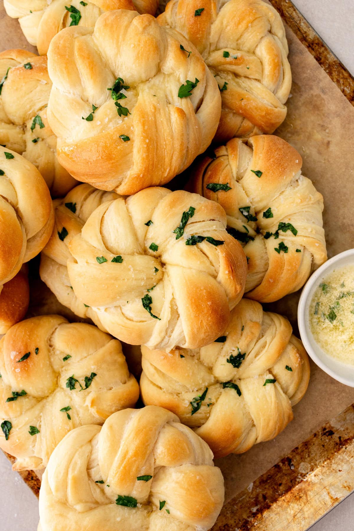 Buttery, fluffy homemade rolls tied in knot and brushed with butter. The perfect knotted rolls recipe!