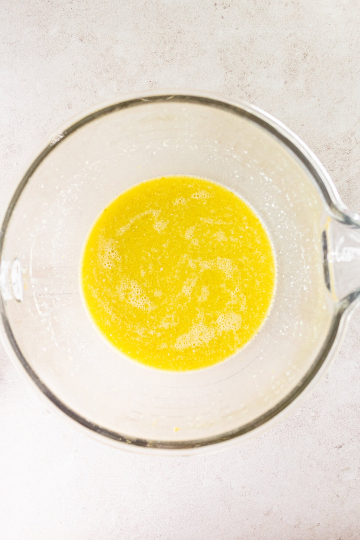 Making homemade lemon olive oil cake batter in a bowl