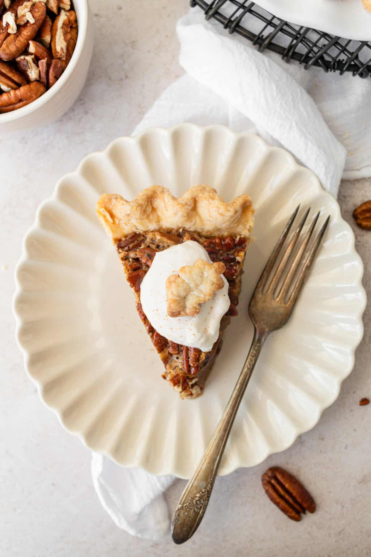 This is the best pecan pie recipe made with a rich, gooey filling with the crunchy, nutty goodness of toasted pecans. It pairs perfectly with a homemade buttery, flaky pie crust. The filling is a sweet blend of brown sugar, eggs, and vanilla, which creates a silky texture that melts in your mouth. You will love this easy pecan pie recipe!