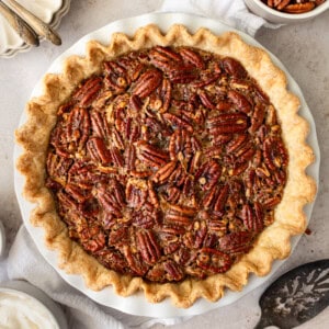 This is the best pecan pie recipe made with a rich, gooey filling with the crunchy, nutty goodness of toasted pecans. It pairs perfectly with a homemade buttery, flaky pie crust. The filling is a sweet blend of brown sugar, eggs, and vanilla, which creates a silky texture that melts in your mouth. You will love this easy pecan pie recipe!