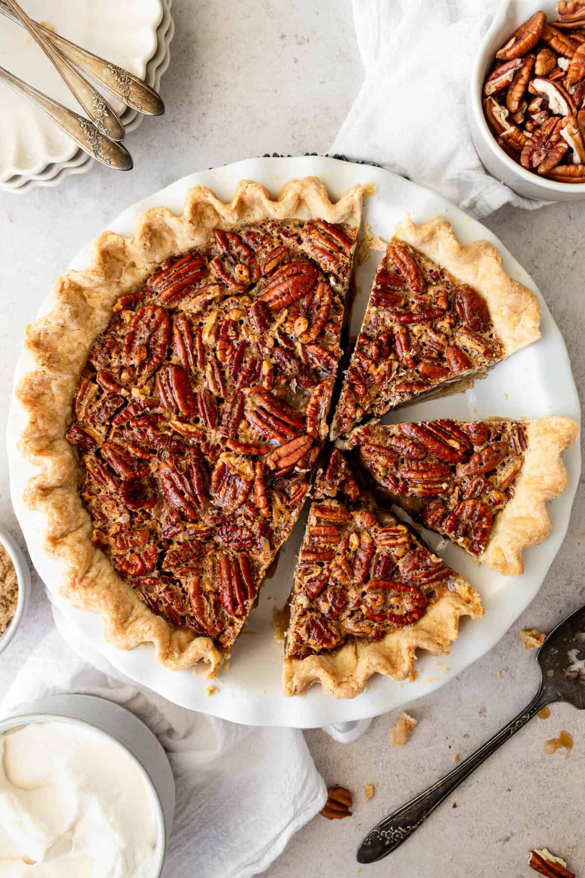 This is the best pecan pie recipe made with a rich, gooey filling with the crunchy, nutty goodness of toasted pecans. It pairs perfectly with a homemade buttery, flaky pie crust. The filling is a sweet blend of brown sugar, eggs, and vanilla, which creates a silky texture that melts in your mouth. You will love this easy pecan pie recipe!