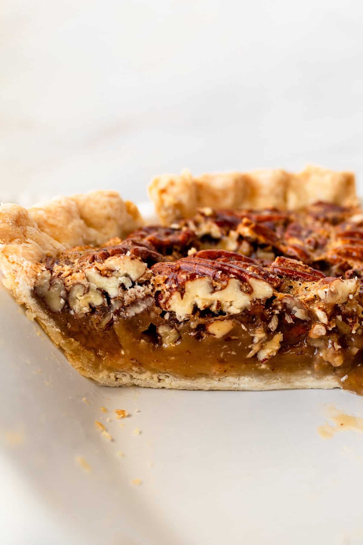 This is the best pecan pie recipe made with a rich, gooey filling with the crunchy, nutty goodness of toasted pecans. It pairs perfectly with a homemade buttery, flaky pie crust. The filling is a sweet blend of brown sugar, eggs, and vanilla, which creates a silky texture that melts in your mouth. You will love this easy pecan pie recipe!