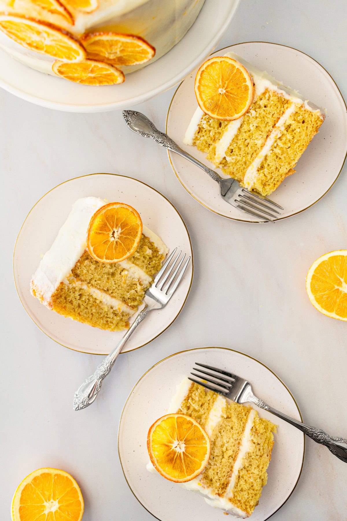 A moist, tender fresh orange cake with a sweet orange cream cheese frosting. This homemade orange cake that is bursting with bright citrus flavor in every bite. Each layer is moist, fluffy, and perfectly enhanced by an orange cream cheese frosting. The fresh orange juice and zest adds fresh orange flavor. Here are tips for making the perfect frosted orange cake! This can also be made into an orange naked cake.