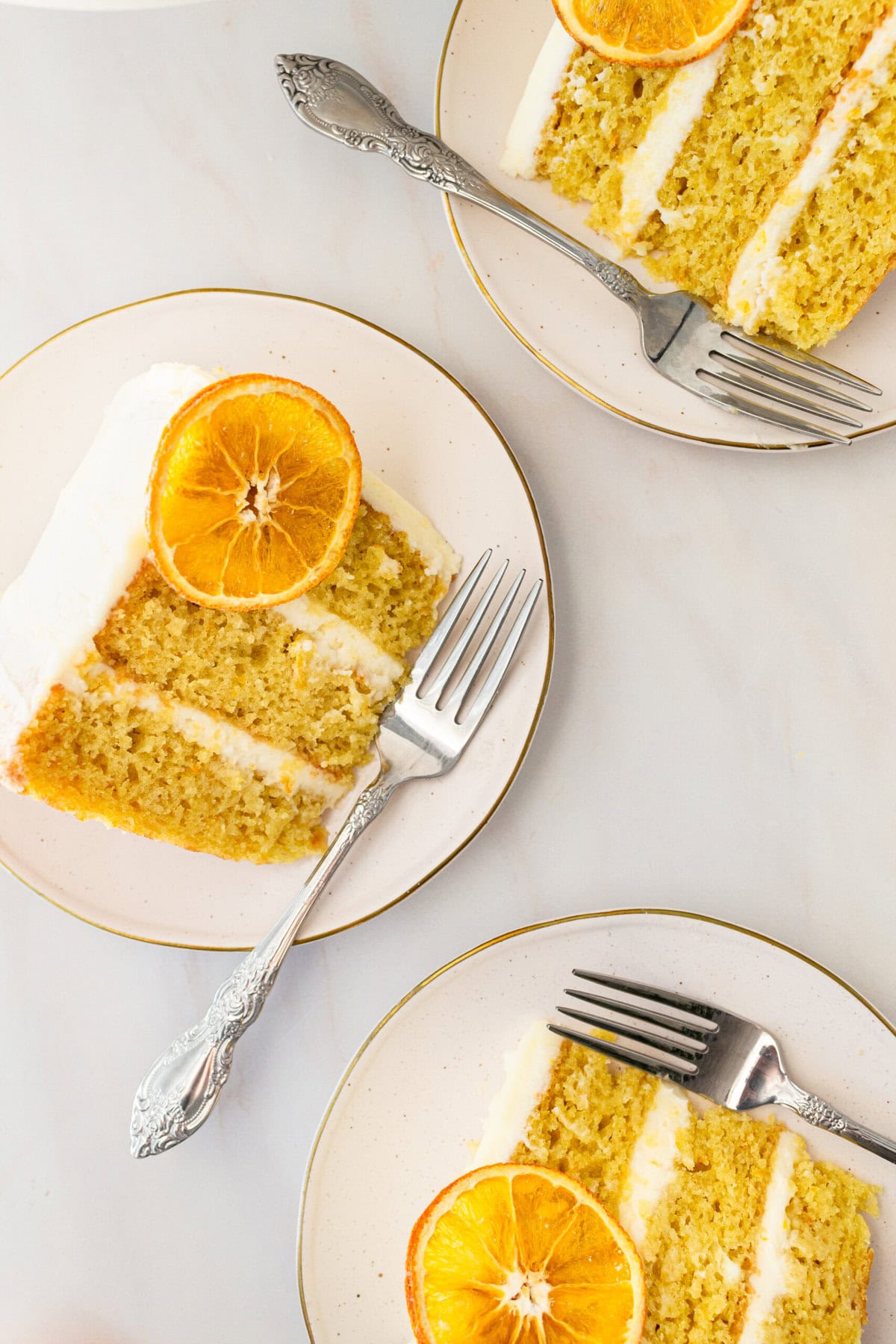 A moist, tender fresh orange cake with a sweet orange cream cheese frosting. This homemade orange cake that is bursting with bright citrus flavor in every bite. Each layer is moist, fluffy, and perfectly enhanced by an orange cream cheese frosting. The fresh orange juice and zest adds fresh orange flavor. Here are tips for making the perfect frosted orange cake! This can also be made into an orange naked cake.