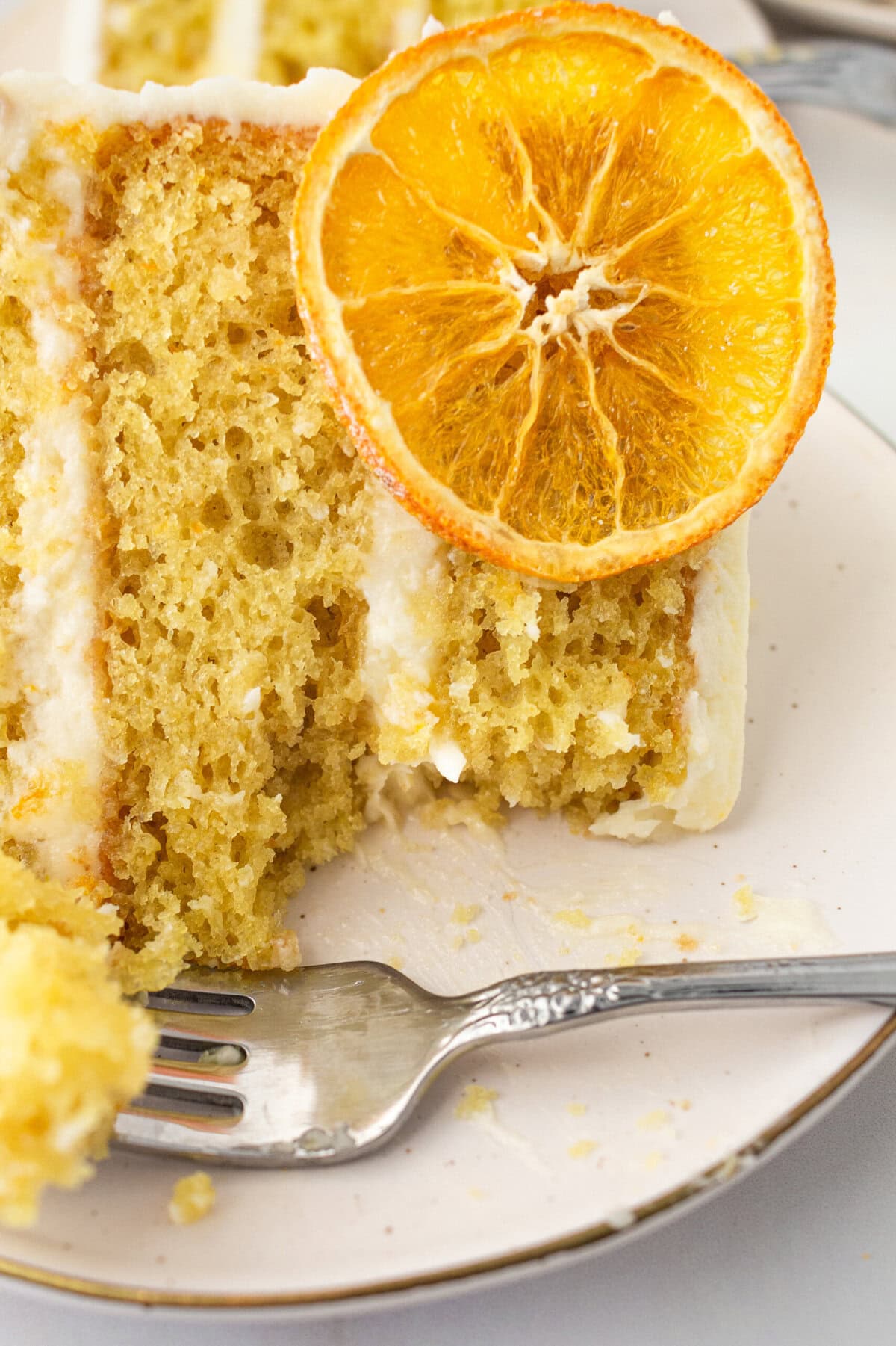 A moist, tender fresh orange cake with a sweet orange cream cheese frosting. This homemade orange cake that is bursting with bright citrus flavor in every bite. Each layer is moist, fluffy, and perfectly enhanced by an orange cream cheese frosting. The fresh orange juice and zest adds fresh orange flavor. Here are tips for making the perfect frosted orange cake! This can also be made into an orange naked cake.