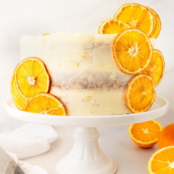 A moist, tender fresh orange cake with a sweet orange cream cheese frosting. This homemade orange cake that is bursting with bright citrus flavor in every bite. Each layer is moist, fluffy, and perfectly enhanced by an orange cream cheese frosting. The fresh orange juice and zest adds fresh orange flavor. Here are tips for making the perfect frosted orange cake! This can also be made into an orange naked cake.