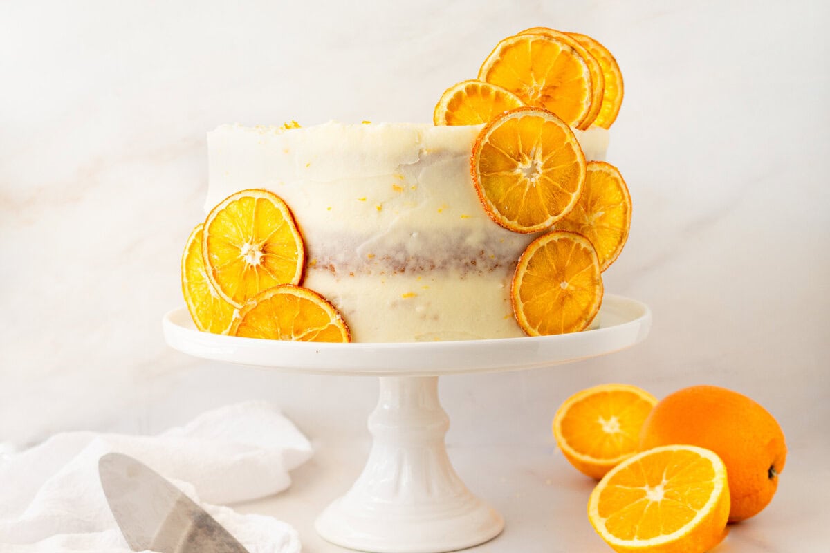 A moist, tender fresh orange cake with a sweet orange cream cheese frosting. This homemade orange cake that is bursting with bright citrus flavor in every bite. Each layer is moist, fluffy, and perfectly enhanced by an orange cream cheese frosting. The fresh orange juice and zest adds fresh orange flavor. Here are tips for making the perfect frosted orange cake! This can also be made into an orange naked cake.