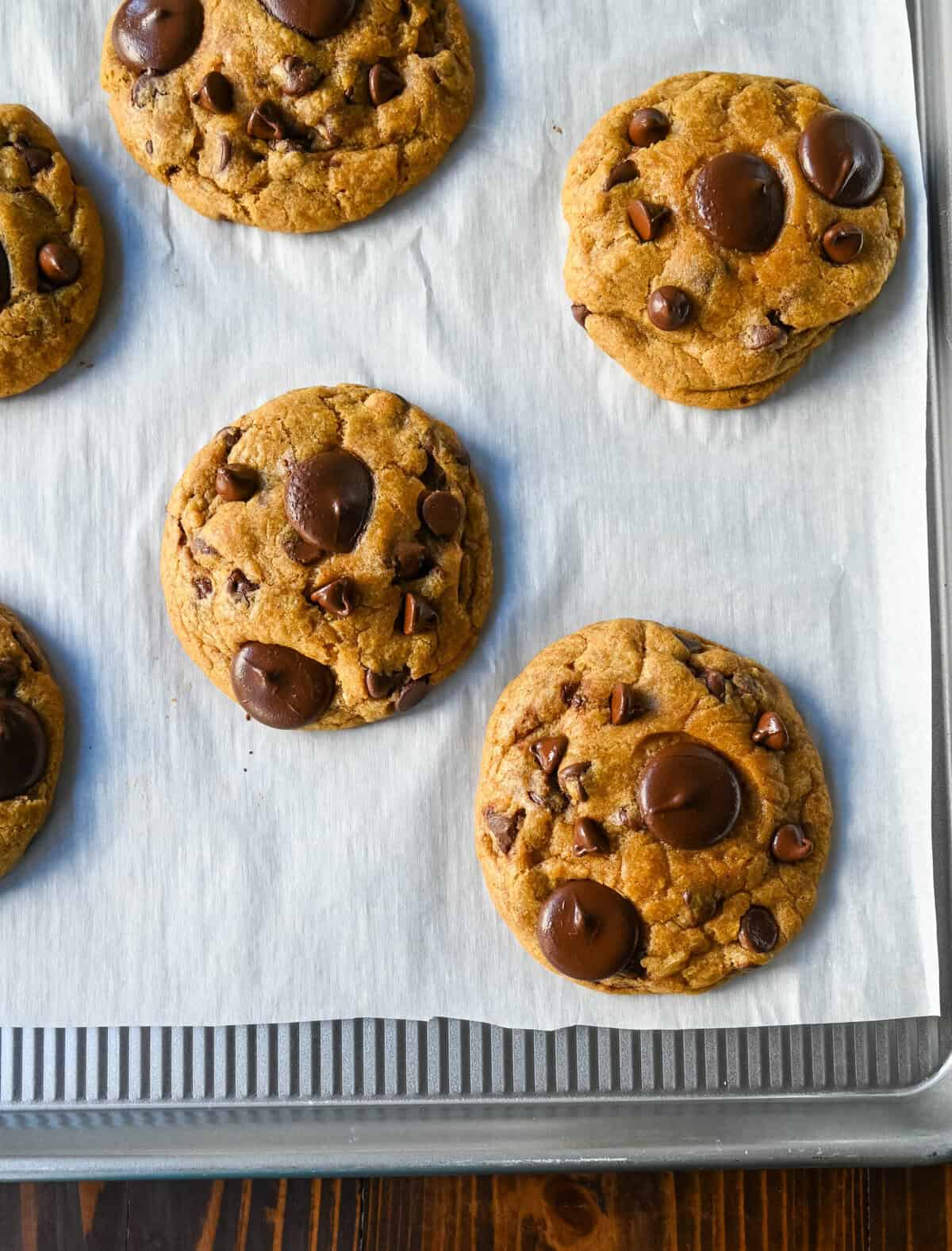 Place chocolate chips on cookies as soon as they come out of the oven. These Brown Butter Pumpkin Chocolate Chip Cookies are made with browned butter, brown sugar, pure pumpkin puree, pumpkin spice, and semisweet chocolate chips. These are the perfect chewy pumpkin chocolate chip cookie recipe!