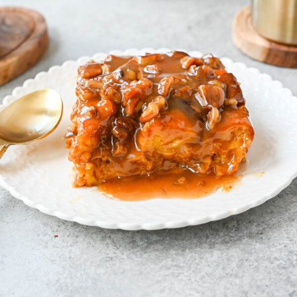 This Pumpkin Praline Bread Pudding is made with brioche bread, homemade pumpkin spice custard and baked until perfectly golden and then topped with a caramel butter pecan sauce. This Pumpkin Bread Pudding with Caramel Pecan Sauce is the perfect Fall comfort food dessert.