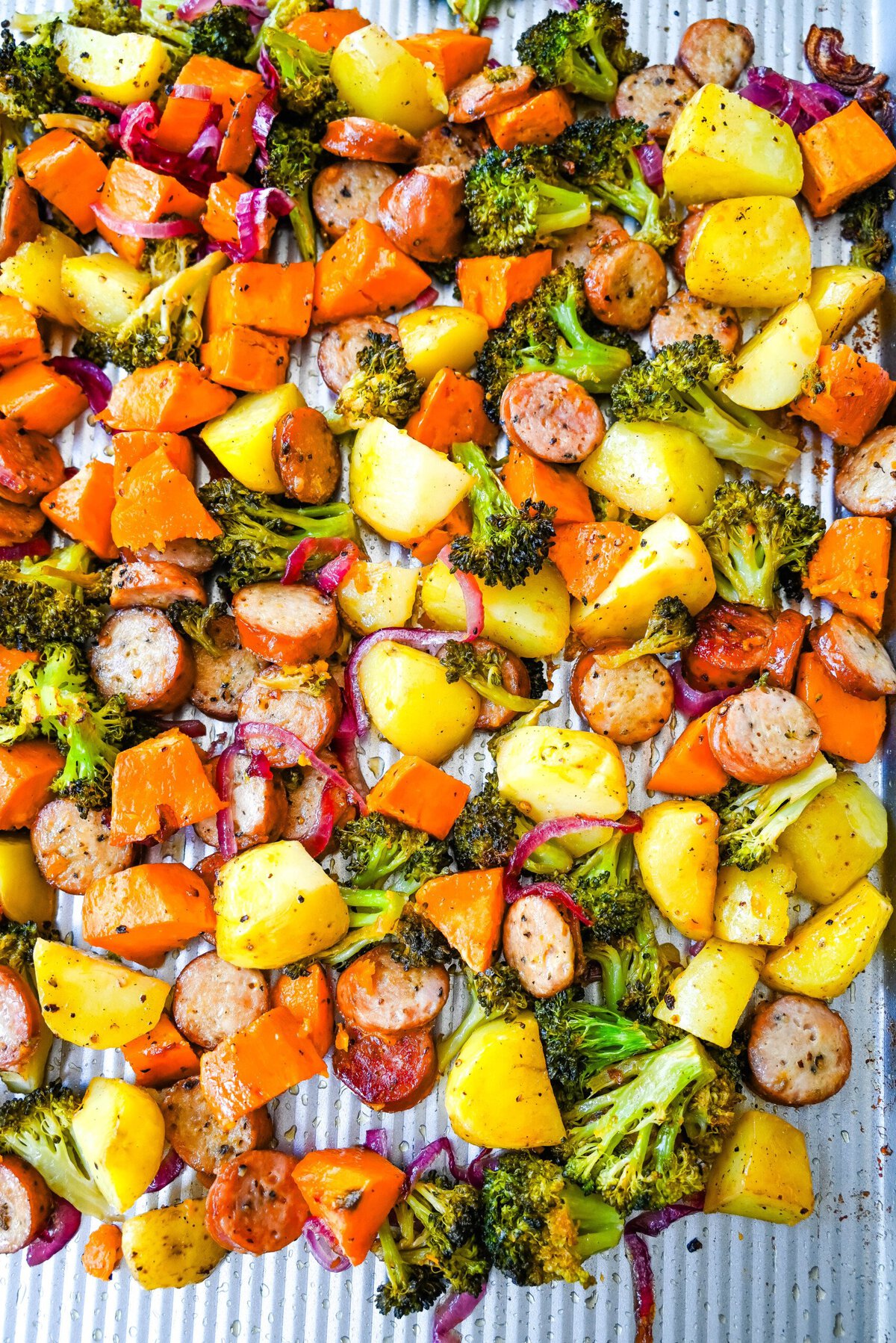 This Sheet Pan Chicken Sausage and Veggies Recipe is made with savory chicken sausage nestled between caramelized, crispy-edged vegetables, all roasted to perfection on a single sheet pan. It's quick, effortless, so delicious, and perfect for busy weeknights or cozy, family-style dinners.