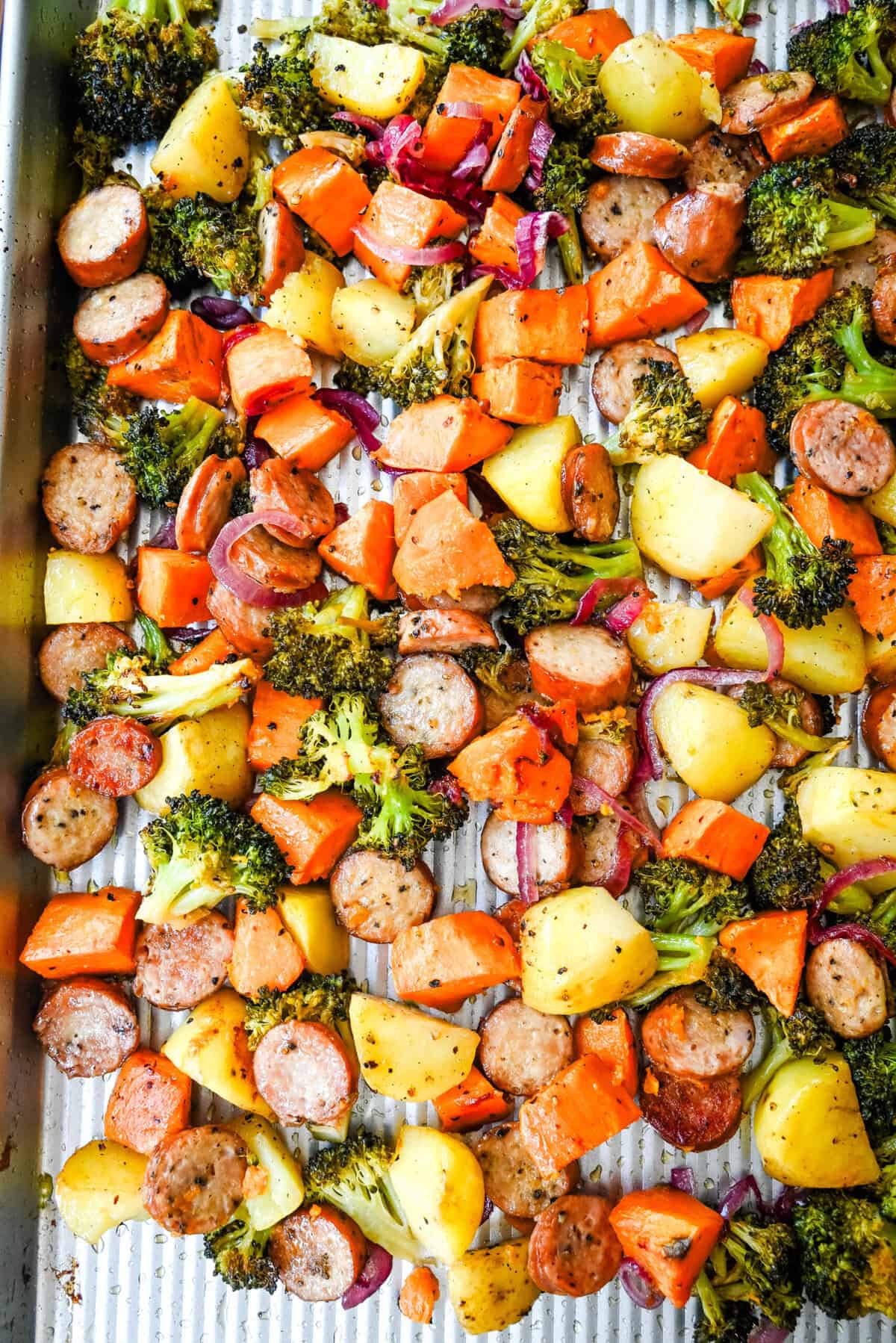 This Sheet Pan Chicken Sausage and Veggies Recipe is made with savory chicken sausage nestled between caramelized, crispy-edged vegetables, all roasted to perfection on a single sheet pan. It's quick, effortless, so delicious, and perfect for busy weeknights or cozy, family-style dinners.