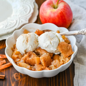 This Apple Cobbler recipe is made with fresh apples sauteed with butter, cinnamon, brown sugar, and apple cider and then baked with the most perfect topping that is sweet, crisp, and pairs perfectly with the fresh apples. This is the best apple cobbler recipe!