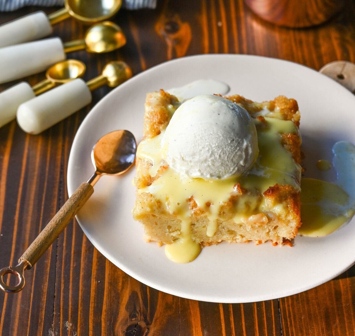 This is the best bread pudding recipe and is the ultimate comfort dessert, with a smooth vanilla bean custard that soaks into rich, day-old bread. Warm spices and vanilla enhance the creamy texture, while a crisp, golden crust forms on top. Finished with a homemade creme anglaise sauce and a dollop of fresh whipped cream. This Bread Pudding with Vanilla Sauce is the perfect comfort food dessert!