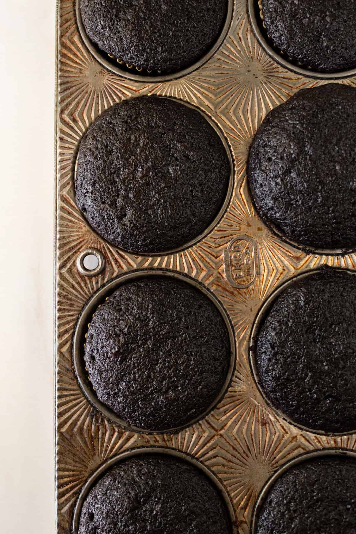 Baked chocolate cupcakes in muffin tins