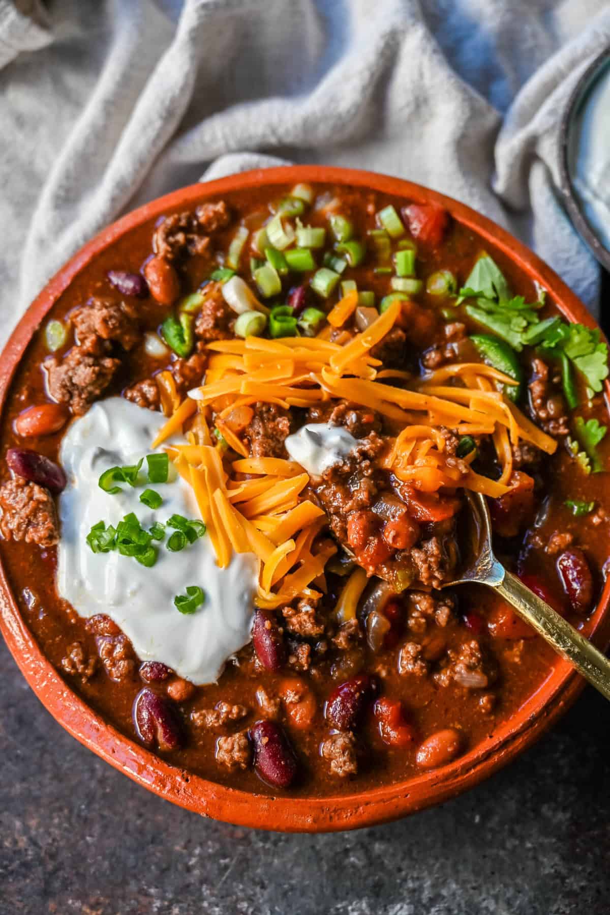 Crockpot Beef Chili. This slow cooker beef chili is the ultimate comforting meal, made even better with a surprising secret ingredient! This crockpot beef chili will be surefire hit and you'll be hooked on how the sweetness and spices come together to create the best crockpot chili.