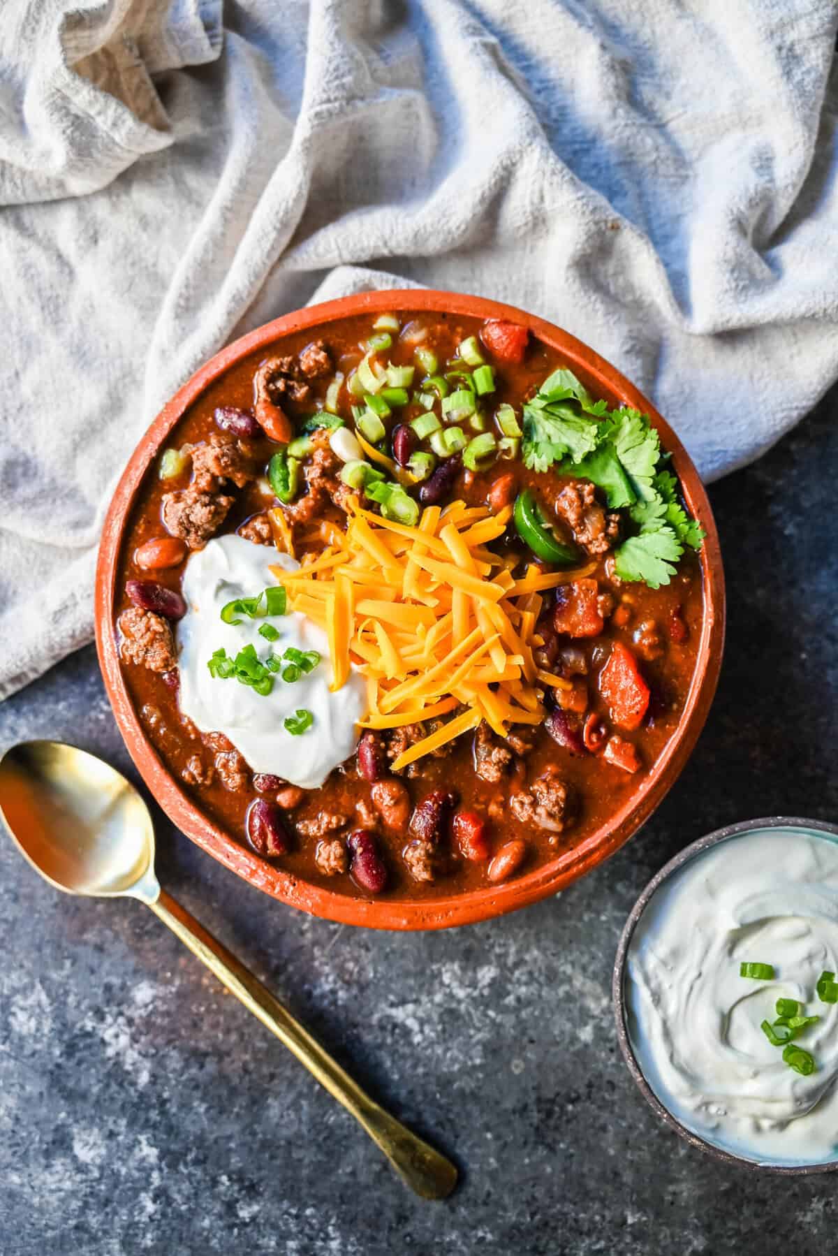 Crockpot Beef Chili. This slow cooker beef chili is the ultimate comforting meal, made even better with a surprising secret ingredient! This crockpot beef chili will be surefire hit and you'll be hooked on how the sweetness and spices come together to create the best crockpot chili.