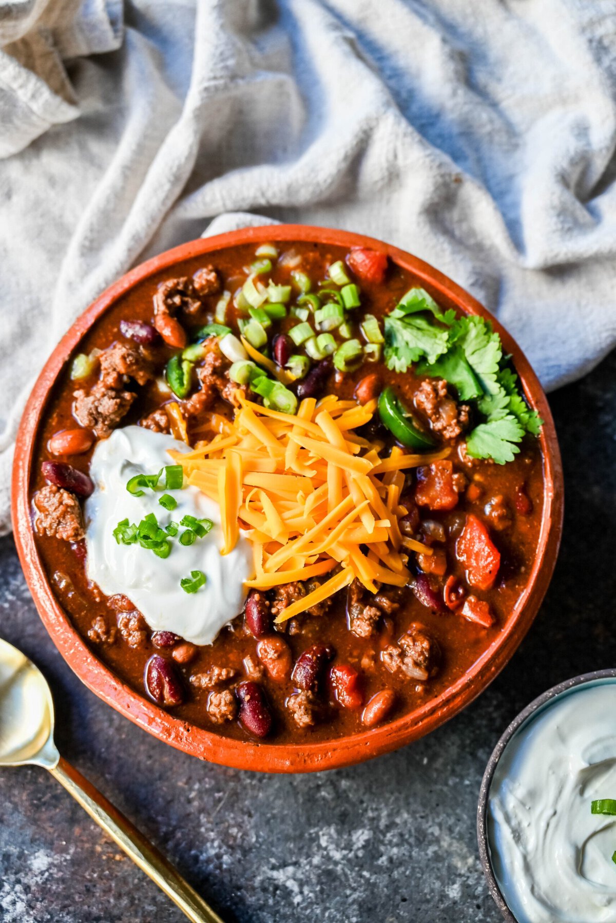 Crockpot Beef Chili. This slow cooker beef chili is the ultimate comforting meal, made even better with a surprising secret ingredient! This crockpot beef chili will be surefire hit and you'll be hooked on how the sweetness and spices come together to create the best crockpot chili.