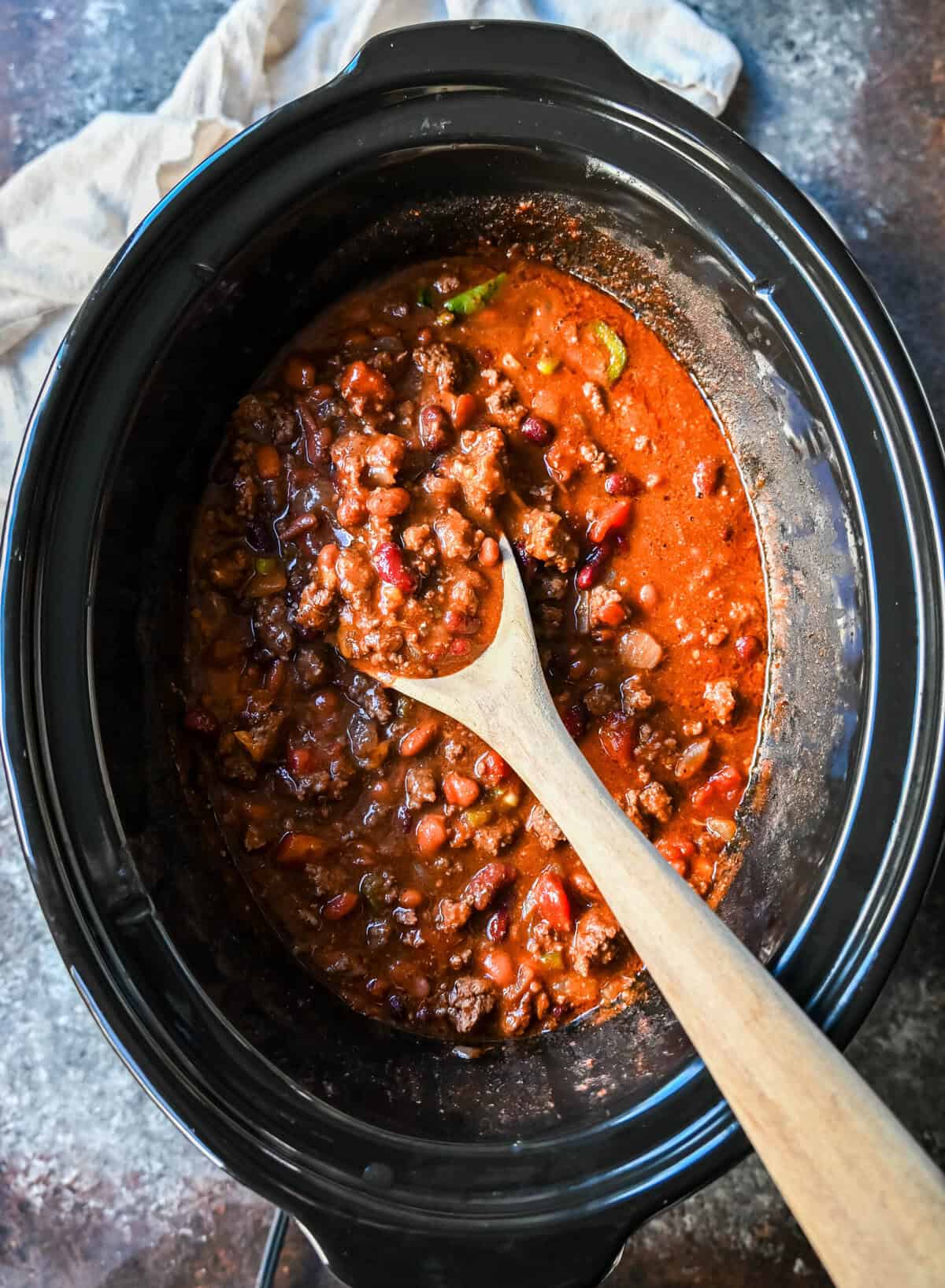 Crockpot Beef Chili. This slow cooker beef chili is the ultimate comforting meal, made even better with a surprising secret ingredient! This crockpot beef chili will be surefire hit and you'll be hooked on how the sweetness and spices come together to create the best crockpot chili.