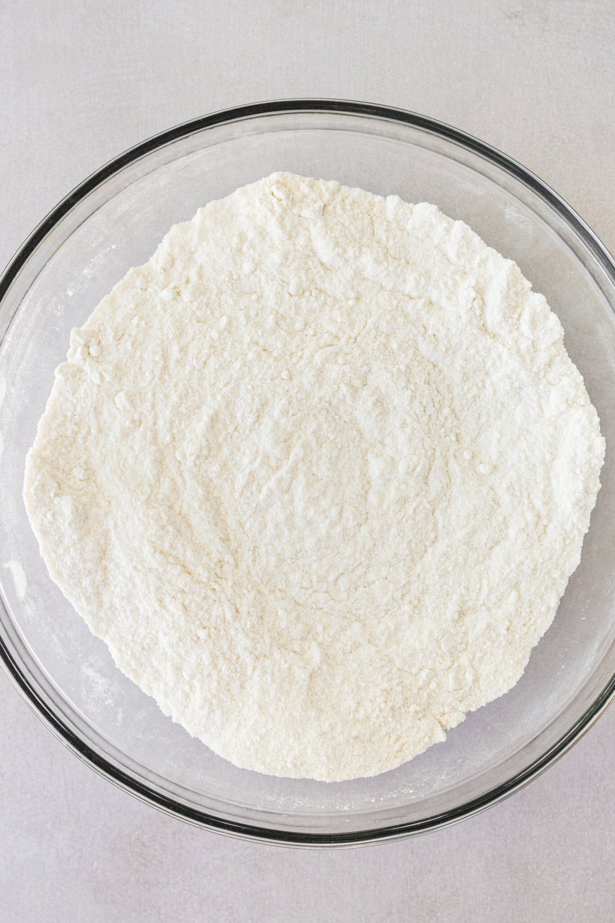 Making a homemade key lime cake with dry ingredients in a bowl