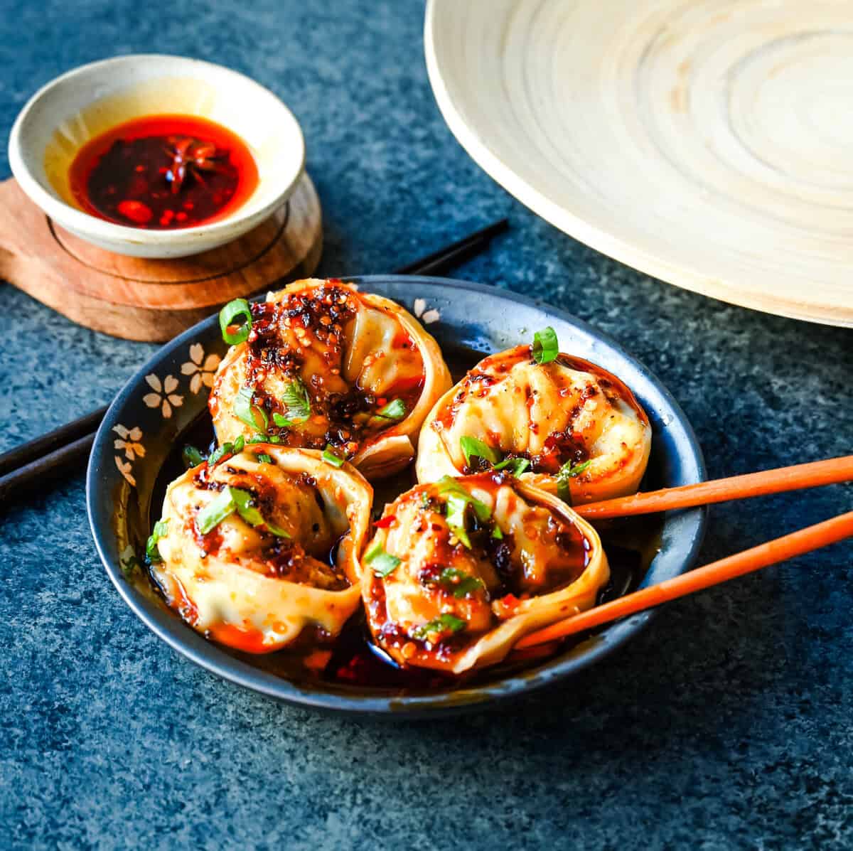 Spicy Wonton Dumplings with Spicy Chili Sauce. How to make the perfect spicy, sweet, and tangy homemade chili sauce to toss on wontons or dumplings for a quick and easy meal. This recipe is reminiscent of the spicy wontons you will find at Din Tai Fung.