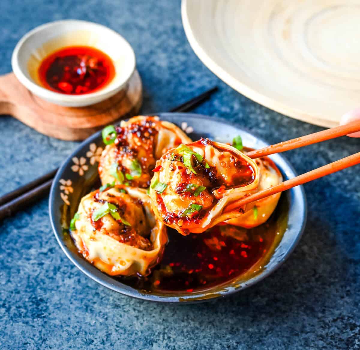 Spicy Wonton Dumplings with Spicy Chili Sauce. How to make the perfect spicy, sweet, and tangy homemade chili sauce to toss on wontons or dumplings for a quick and easy meal. This recipe is reminiscent of the spicy wontons you will find at Din Tai Fung.