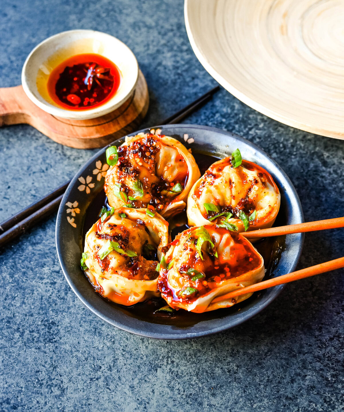 Spicy Wonton Dumplings with Spicy Chili Sauce. How to make the perfect spicy, sweet, and tangy homemade chili sauce to toss on wontons or dumplings for a quick and easy meal. This recipe is reminiscent of the spicy wontons you will find at Din Tai Fung.