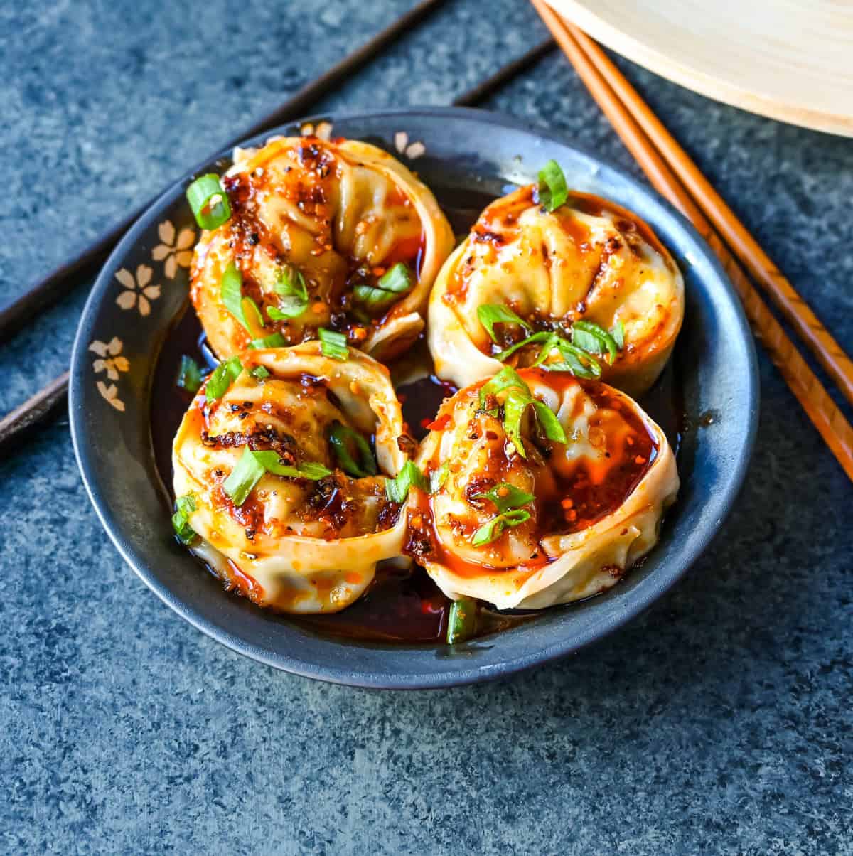 Spicy Wonton Dumplings with Spicy Chili Sauce. How to make the perfect spicy, sweet, and tangy homemade chili sauce to toss on wontons or dumplings for a quick and easy meal. This recipe is reminiscent of the spicy wontons you will find at Din Tai Fung.