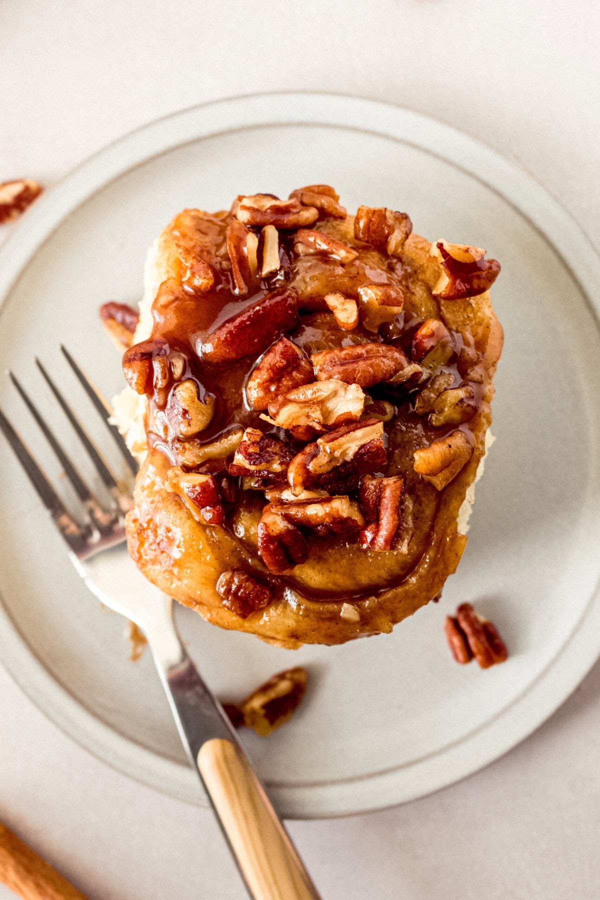 Caramel pecan sticky buns also known as caramel pecan rolls are homemade sweet rolls filled with a brown sugar cinnamon filling and topped with a rich caramel sauce and pecans. Sweet, nutty, and rich, this is the best sticky bun recipe!