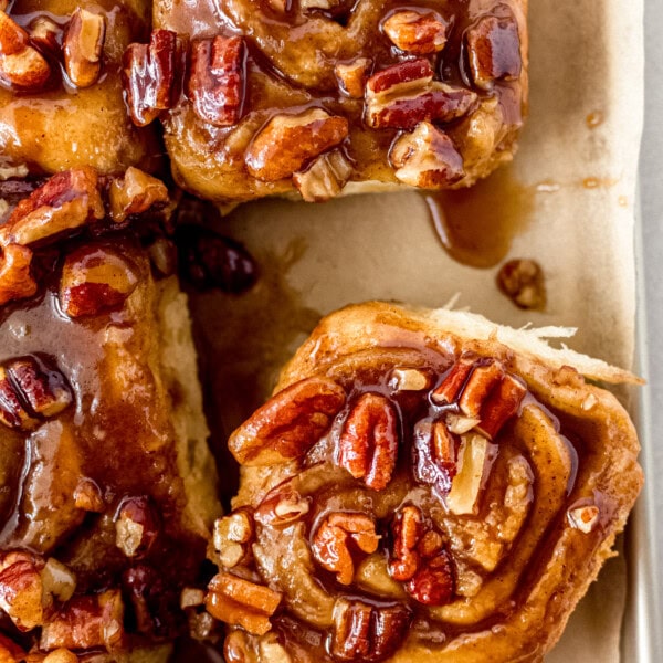 Caramel pecan sticky buns also known as caramel pecan rolls are homemade sweet rolls filled with a brown sugar cinnamon filling and topped with a rich caramel sauce and pecans. Sweet, nutty, and rich, this is the best sticky bun recipe!