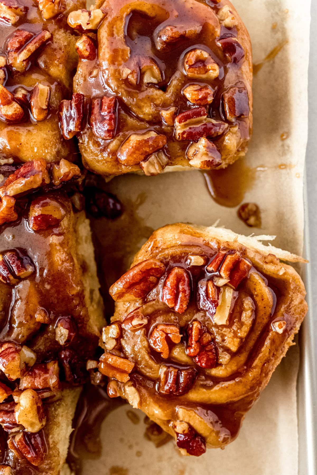 Caramel pecan sticky buns also known as caramel pecan rolls are homemade sweet rolls filled with a brown sugar cinnamon filling and topped with a rich caramel sauce and pecans. Sweet, nutty, and rich, this is the best sticky bun recipe!