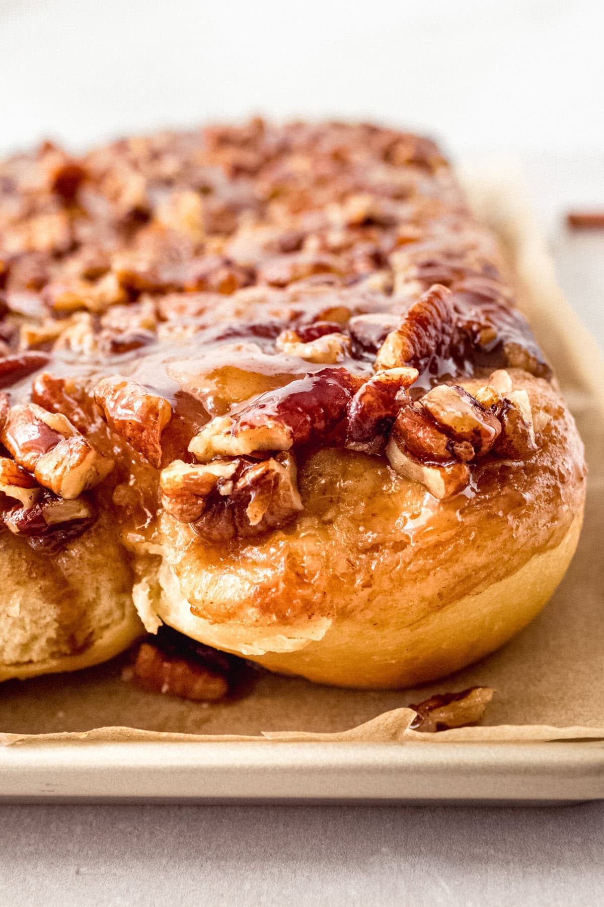 Caramel pecan sticky buns also known as caramel pecan rolls are homemade sweet rolls filled with a brown sugar cinnamon filling and topped with a rich caramel sauce and pecans. Sweet, nutty, and rich, this is the best sticky bun recipe!