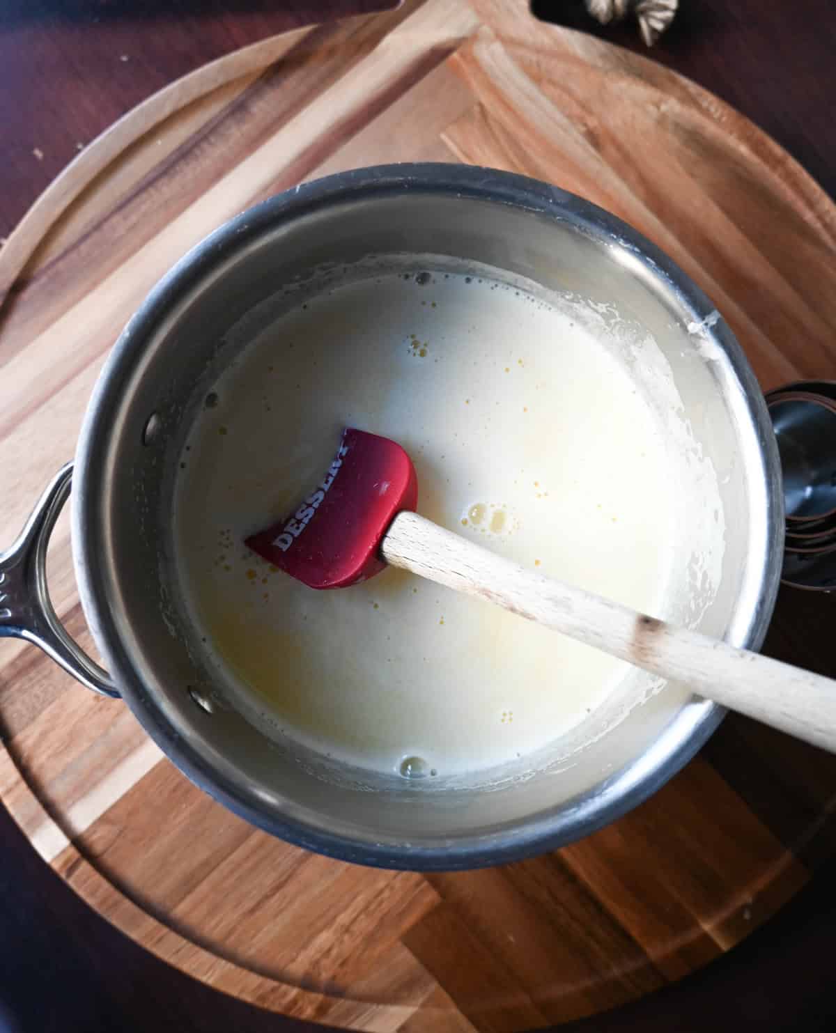 Heat milk and cream in a saucepan to make vanilla sauce or creme anglaise.