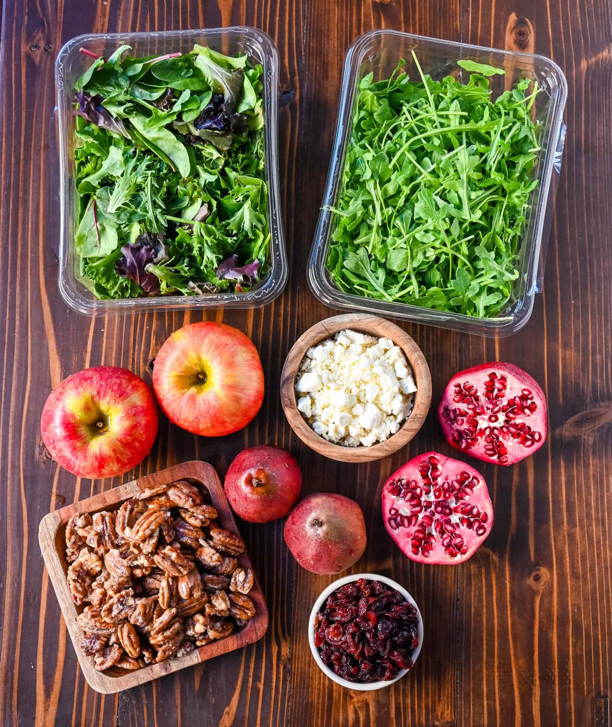 Autumn Honeycrisp Apple and Candied Pecan Salad Ingredients. Spring mix, apple, pear, pomegranate, dried cranberries, feta or goat cheese, and a maple dressing.