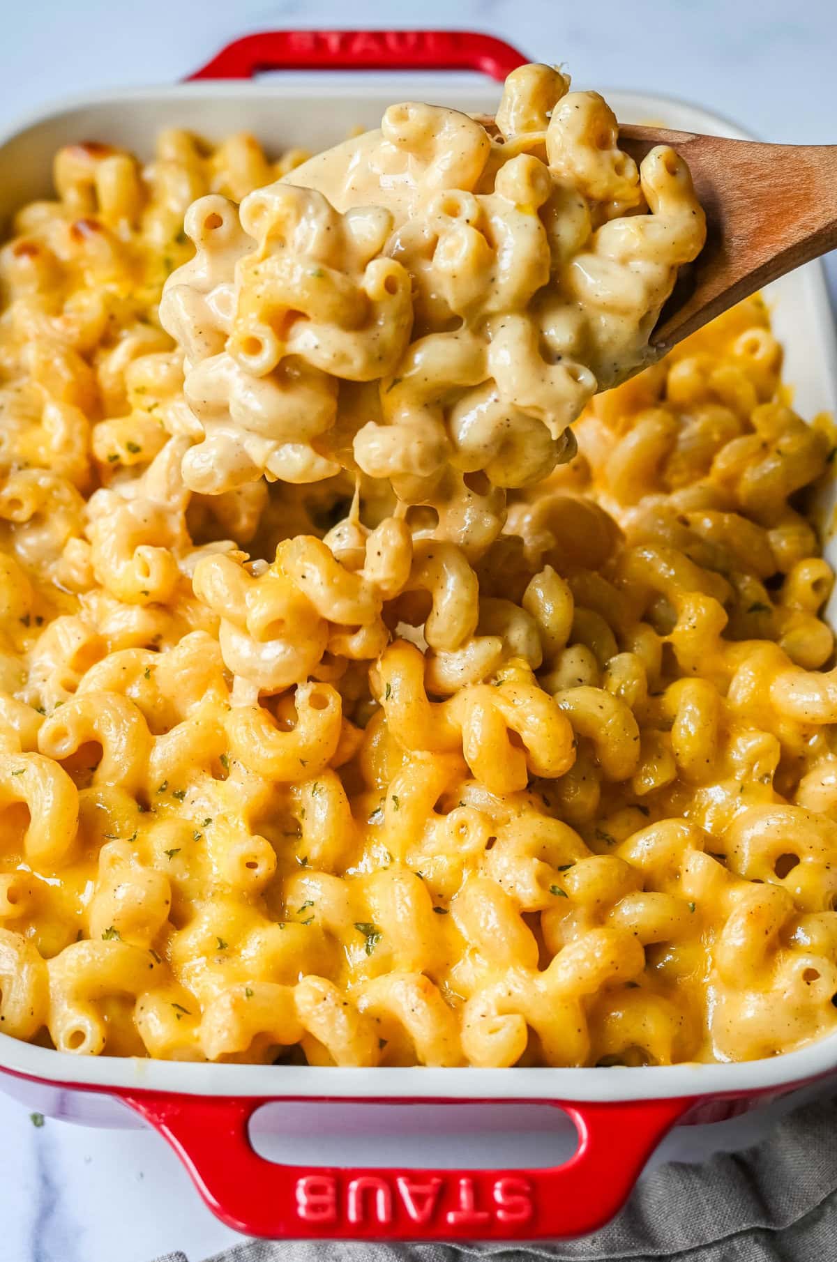 A plate of easy homemade mac and cheese. How to make a quick, easy, creamy, cheesy homemade mac and cheese recipe. All of the tips and tricks for making a velvety cheese sauce that is completely smooth. You will love this easy mac and cheese recipe!