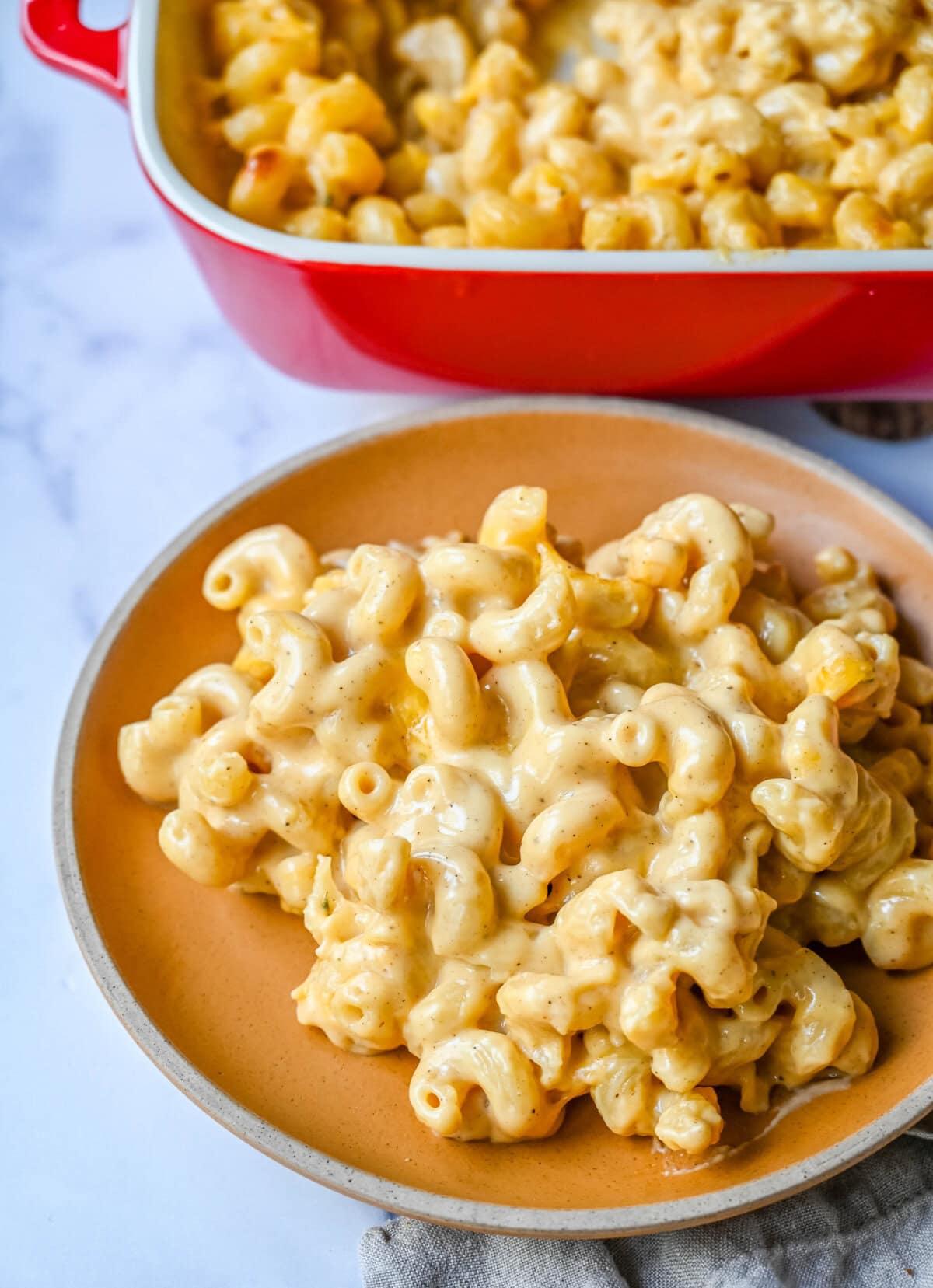 A plate of easy homemade mac and cheese. How to make a quick, easy, creamy, cheesy homemade mac and cheese recipe. All of the tips and tricks for making a velvety cheese sauce that is completely smooth. You will love this easy mac and cheese recipe!