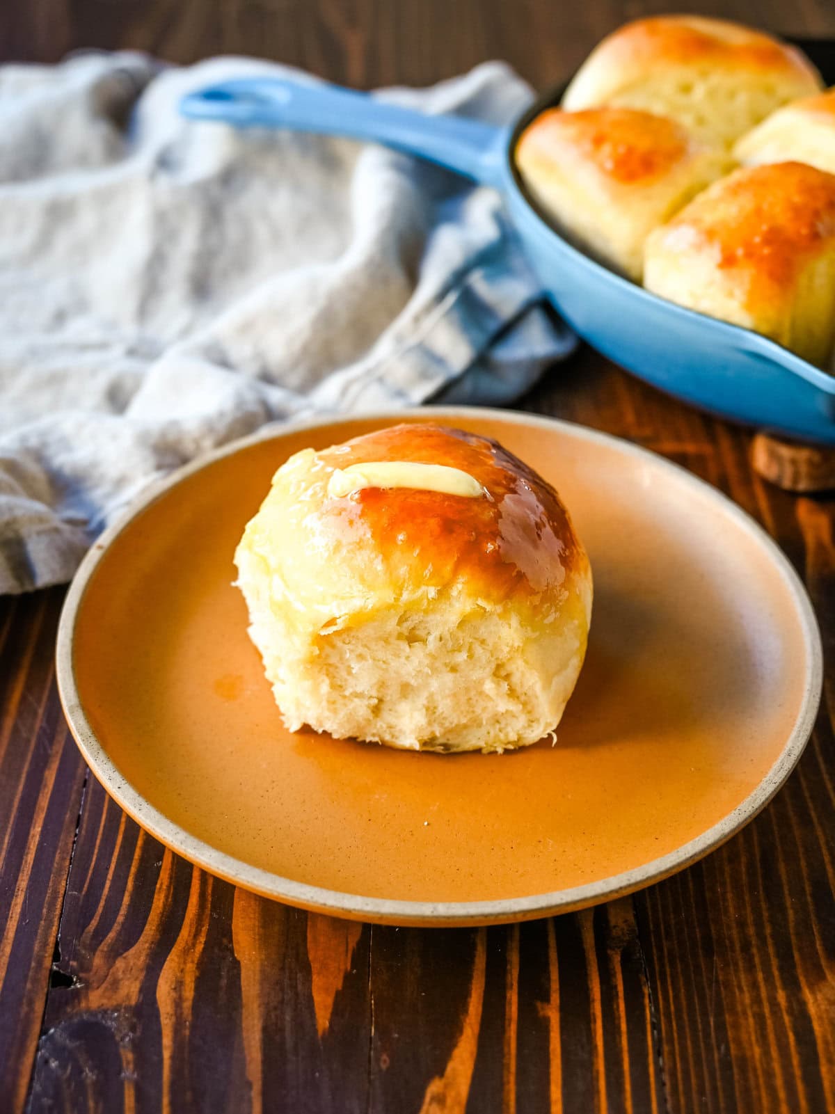 Homemade dinner roll on plate. These Japanese milk bread dinner rolls are the most soft, fluffy, and tender homemade rolls due to a special technique. This game changing technique makes all of the difference for making melt-in-your-mouth rolls.