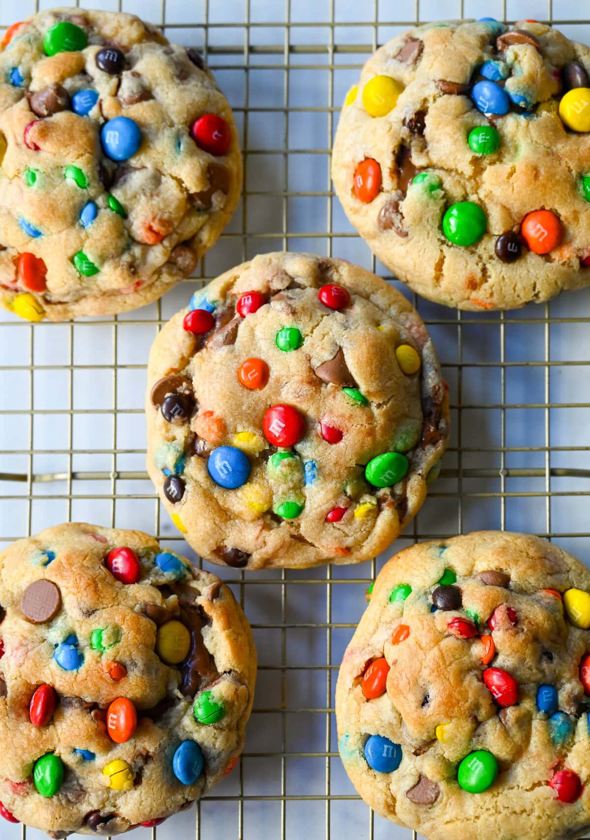 These M&M Nutella Stuffed Cookies are made with milk chocolate chip and M&M cookies filled with creamy chocolate hazelnut Nutella spread and baked until perfectly soft and chewy.