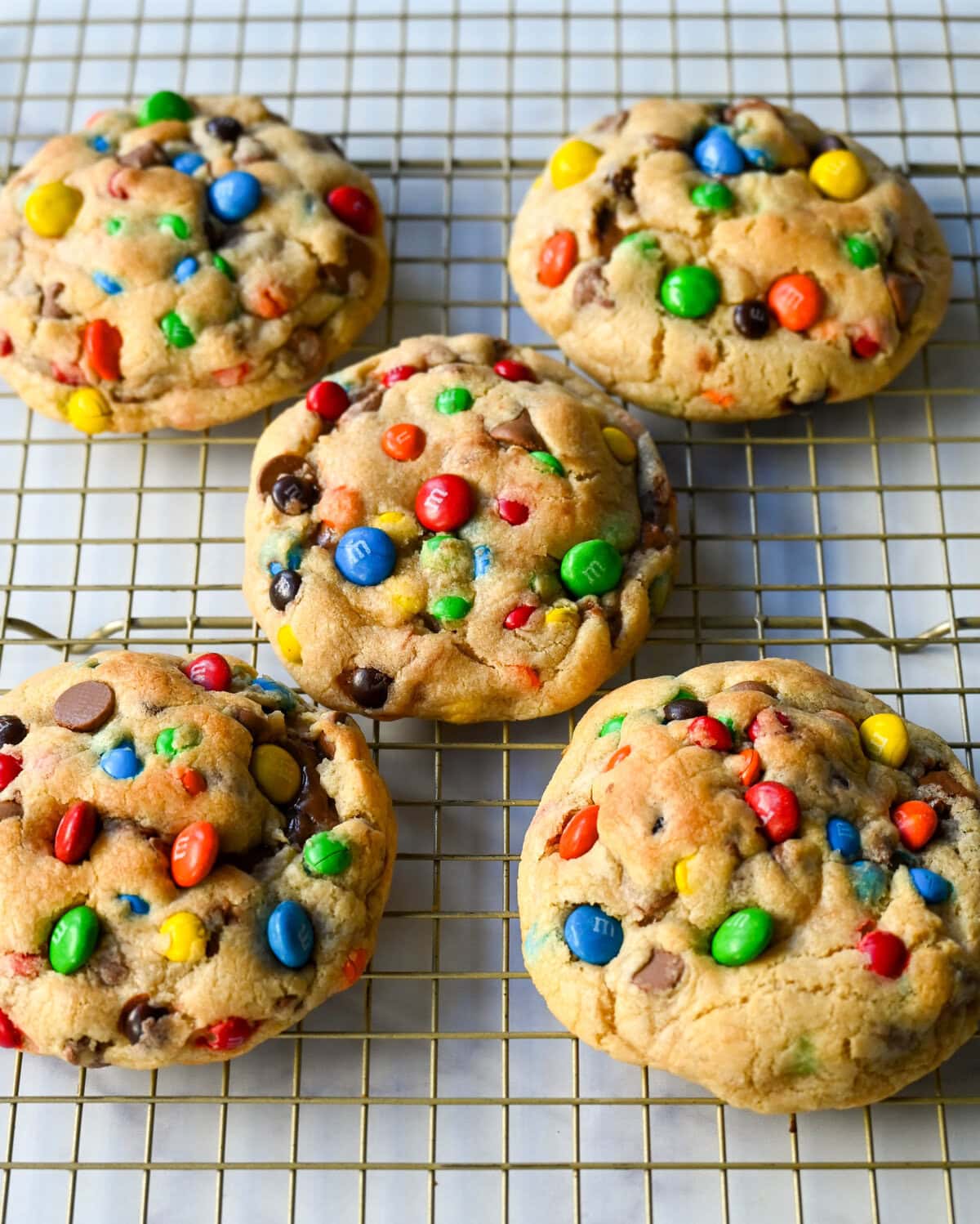 These M&M Nutella Stuffed Cookies are made with milk chocolate chip and M&M cookies filled with creamy chocolate hazelnut Nutella spread and baked until perfectly soft and chewy.