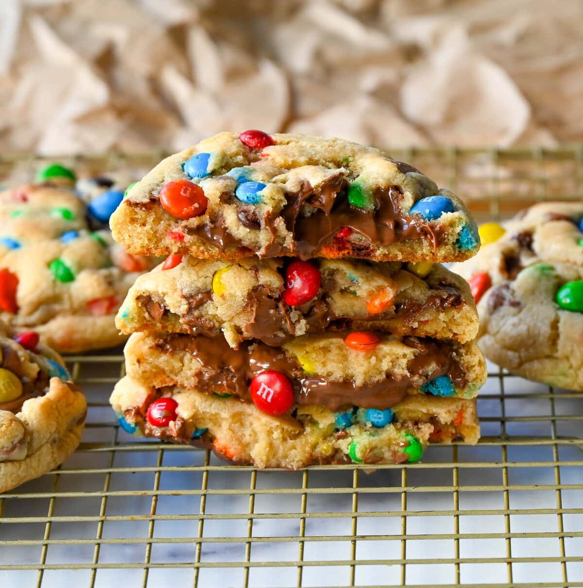 These M&M Nutella Stuffed Cookies are made with milk chocolate chip and M&M cookies filled with creamy chocolate hazelnut Nutella spread and baked until perfectly soft and chewy.