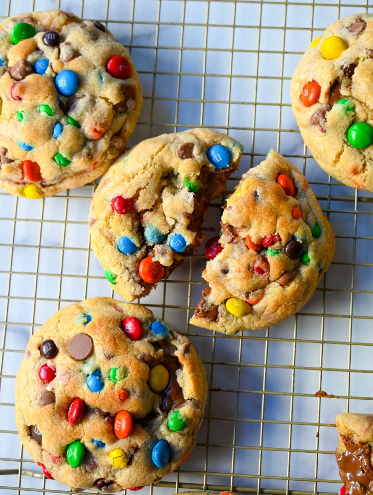 These M&M Nutella Stuffed Cookies are made with milk chocolate chip and M&M cookies filled with creamy chocolate hazelnut Nutella spread and baked until perfectly soft and chewy.