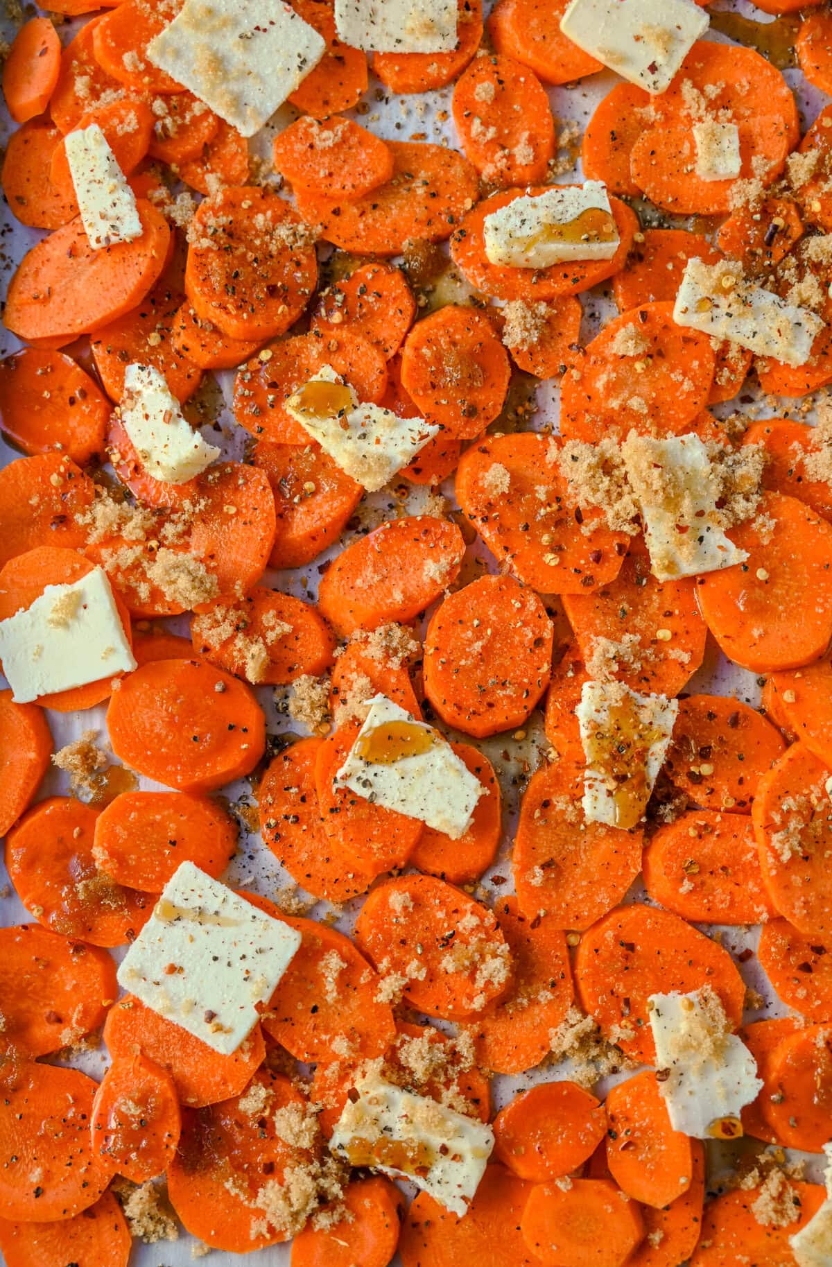 Roasted Maple Glazed Carrots on baking sheet to roast in the oven.