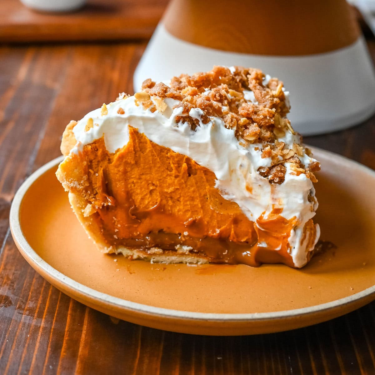 Milk Bar Hilly's Pumpkin Caramel Pie Recipe. How to make the famous, viral NYC's Milk Bar Pumpkin Caramel Pie. This pie starts with a homemade pie crust, filled with a spiced pumpkin white chocolate ganache, salted caramel, fresh sweetened whipped cream, and a homemade streusel topping. You will love this Pumpkin Caramel Pie Recipe!