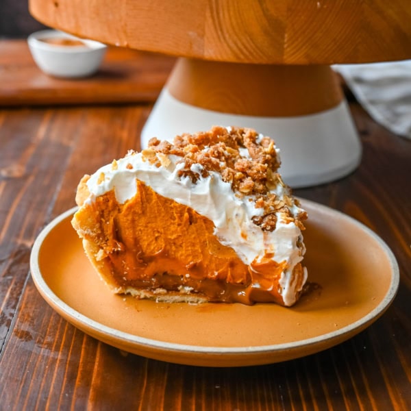 Milk Bar Hilly's Pumpkin Caramel Pie Recipe. How to make the famous, viral NYC's Milk Bar Pumpkin Caramel Pie. This pie starts with a homemade pie crust, filled with a spiced pumpkin white chocolate ganache, salted caramel, fresh sweetened whipped cream, and a homemade streusel topping. You will love this Pumpkin Caramel Pie Recipe!