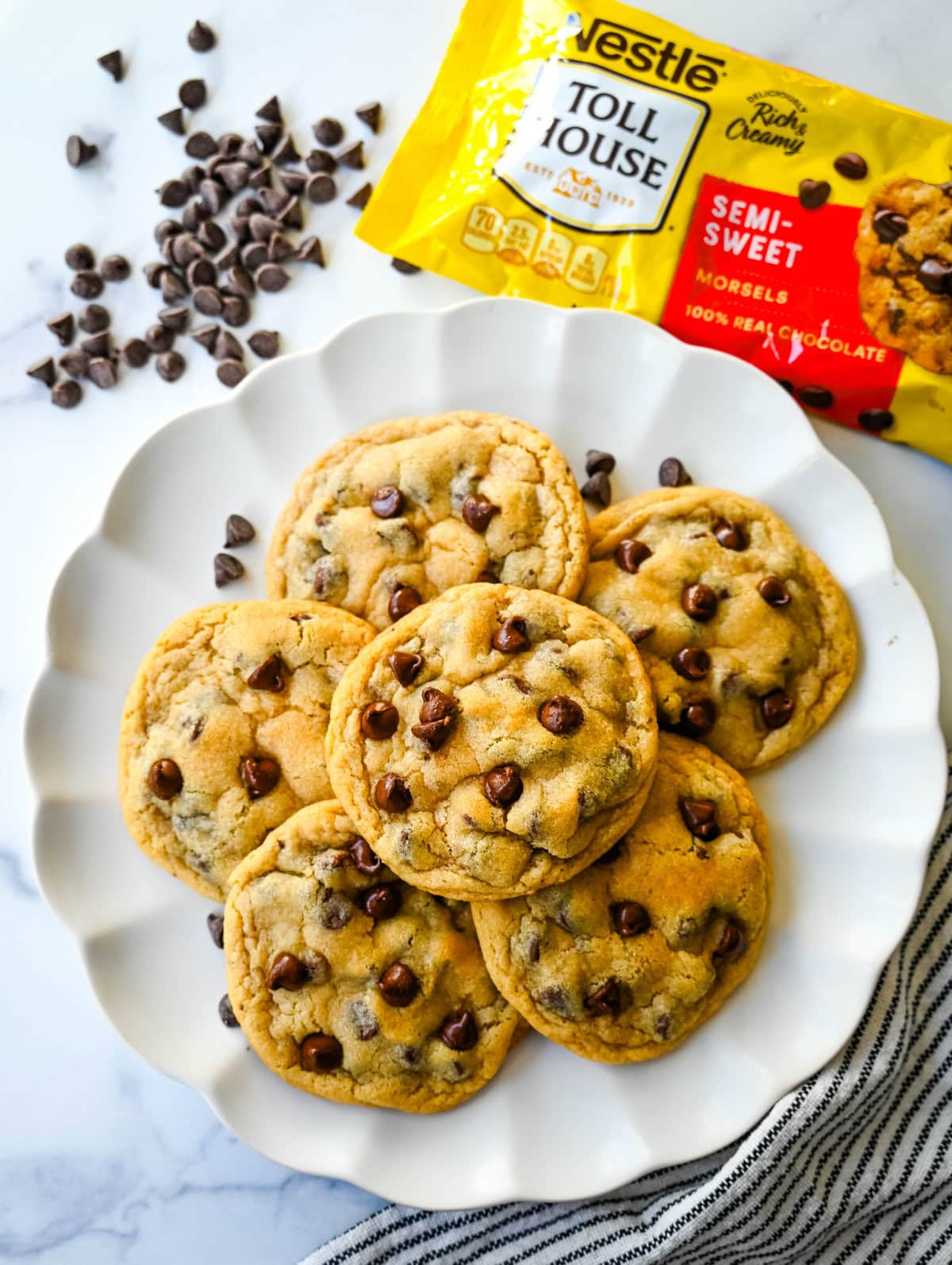 The Nestle Toll House Chocolate Chip Cookie Recipe. How to make the original Toll House chocolate chip cookie recipe on the bag. Tips for making the best Toll house chocolate chip cookies. Chocolate chip cookies on a plate with a yellow Nestle Toll House chocolate chips bag.