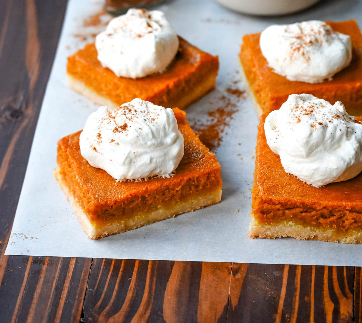 These homemade Pumpkin Pie Bars are made with a buttery shortbread crust and topped with a creamy pumpkin cream cheese filling and baked. These easy pumpkin pie bars are topped with fresh whipped cream and cut into squares for an easy alternative to pumpkin pie.