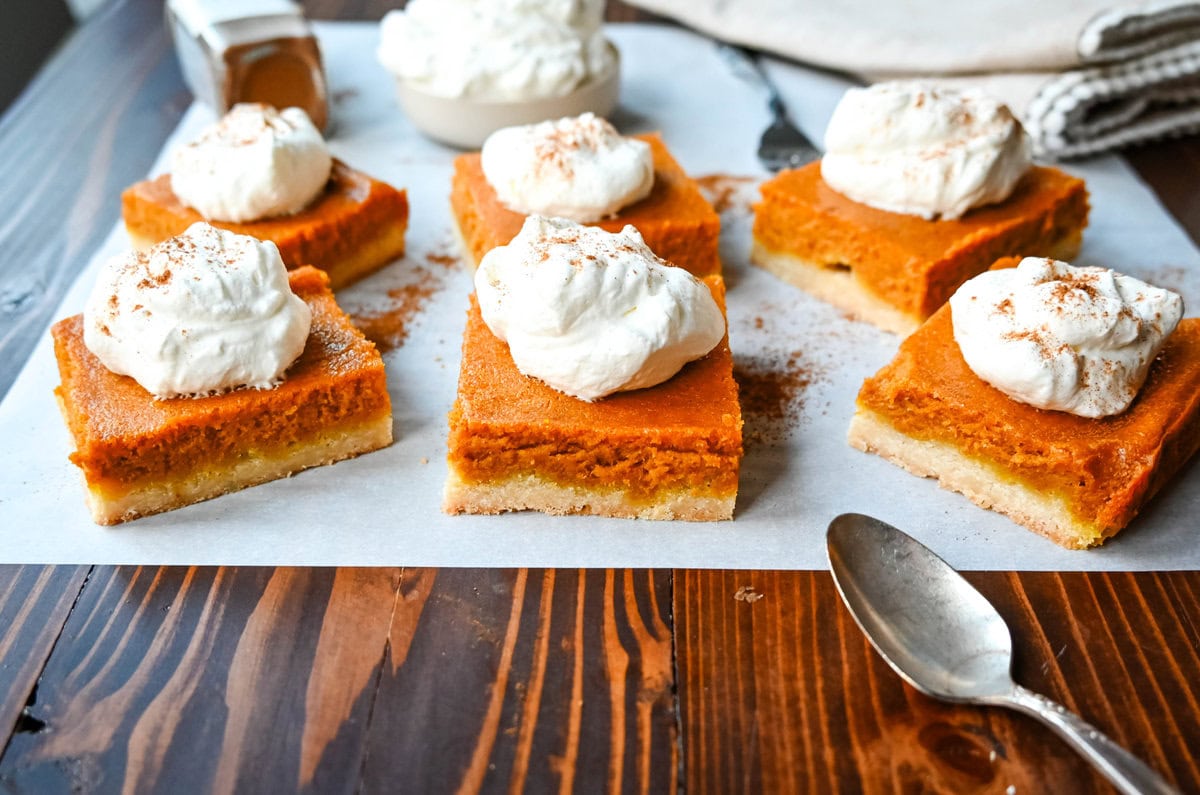 These homemade Pumpkin Pie Bars are made with a buttery shortbread crust and topped with a creamy pumpkin cream cheese filling and baked. These easy pumpkin pie bars are topped with fresh whipped cream and cut into squares for an easy alternative to pumpkin pie.