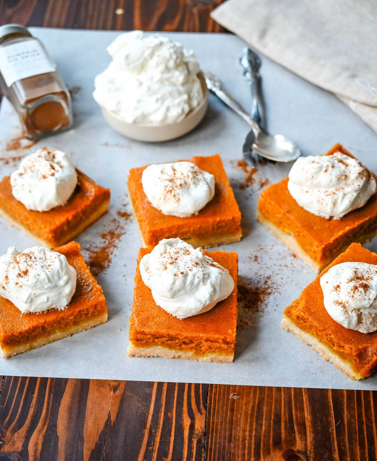 These homemade Pumpkin Pie Bars are made with a buttery shortbread crust and topped with a creamy pumpkin cream cheese filling and baked. These easy pumpkin pie bars are topped with fresh whipped cream and cut into squares for an easy alternative to pumpkin pie.