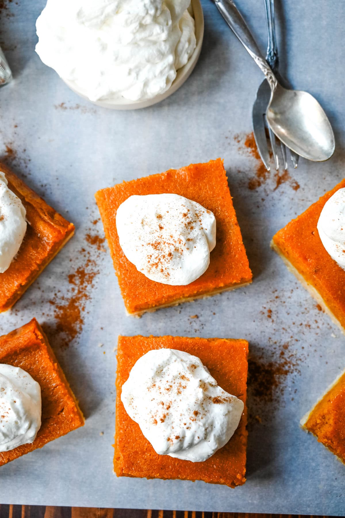 These homemade Pumpkin Pie Bars are made with a buttery shortbread crust and topped with a creamy pumpkin cream cheese filling and baked. These easy pumpkin pie bars are topped with fresh whipped cream and cut into squares for an easy alternative to pumpkin pie.